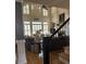 Bright living room featuring soaring windows with shutters, ceiling fan, and hardwood flooring at 2930 Aquitania Ln, Cumming, GA 30040