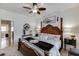 Comfortable primary bedroom with a four-poster bed, ceiling fan and carpeted floors at 2930 Aquitania Ln, Cumming, GA 30040