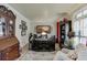 Well-appointed home office featuring custom desk, built-in shelving, and a comfortable seating area with natural light at 2930 Aquitania Ln, Cumming, GA 30040