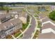 Townhome community aerial view features a pond, landscaping, parking, and walking trails at 4259 Baden Aly, Duluth, GA 30097