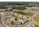 Aerial view of townhome community featuring pond, landscaping, and ample parking at 4259 Baden Aly, Duluth, GA 30097