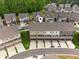 Aerial view of townhomes and neighborhood with well-maintained landscaping and parking areas at 4259 Baden Aly, Duluth, GA 30097