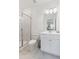 Fresh bathroom featuring marble tile, glass shower, and vanity with cabinet storage at 4259 Baden Aly, Duluth, GA 30097