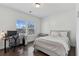 Cozy bedroom featuring hardwood floors, a comfortable bed, and a desk next to a window at 4259 Baden Aly, Duluth, GA 30097