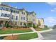 Exterior of townhome featuring a well-manicured lawn, landscaping, and brick facade at 4259 Baden Aly, Duluth, GA 30097