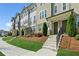 Inviting townhome exterior featuring a manicured lawn, steps to the entry, and attractive architectural details at 4259 Baden Aly, Duluth, GA 30097