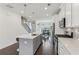 Bright kitchen featuring white cabinets, quartz countertops, stainless appliances and open view to dining area at 4259 Baden Aly, Duluth, GA 30097