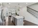 Open kitchen with stainless steel appliances, quartz countertops, island seating, and hardwood floors at 4259 Baden Aly, Duluth, GA 30097