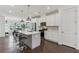 Modern kitchen with white cabinets, stainless steel appliances, a center island and dark hardwood floors at 4259 Baden Aly, Duluth, GA 30097