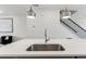 Close up of kitchen island featuring stainless steel sink and faucet with seating for entertaining at 4259 Baden Aly, Duluth, GA 30097