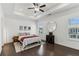 Spacious main bedroom with tray ceiling, ceiling fan and a large window letting in natural light at 4259 Baden Aly, Duluth, GA 30097