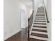 Elegant staircase with wood treads, an iron railing, and natural light creates a striking architectural feature at 4259 Baden Aly, Duluth, GA 30097