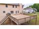 Elevated wooden deck overlooks the backyard, featuring sturdy railings and access to the lush lawn at 60 Heritage Keep, Covington, GA 30016