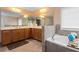 A bathroom with a large mirror, double sinks, and a bathtub for convenience and comfort at 60 Heritage Keep, Covington, GA 30016