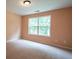 A bright and airy bedroom with fresh paint and plush carpeting offers a serene retreat for rest and rejuvenation at 60 Heritage Keep, Covington, GA 30016