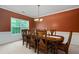 Formal dining room with dark wood table set and natural lighting at 60 Heritage Keep, Covington, GA 30016