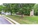 Spacious home featuring a large, lush green lawn with mature trees enhancing its curb appeal at 60 Heritage Keep, Covington, GA 30016