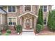 Close-up of the home's entrance, showcasing the front door, porch, and manicured shrubs at 60 Heritage Keep, Covington, GA 30016