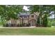 Charming brick home features a well-manicured lawn, mature landscaping, and a welcoming front entrance at 60 Heritage Keep, Covington, GA 30016