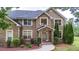 Charming brick home featuring manicured landscaping and a welcoming front entrance at 60 Heritage Keep, Covington, GA 30016