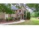 Beautiful brick home with meticulous landscaping, featuring trimmed evergreens near the front entrance at 60 Heritage Keep, Covington, GA 30016