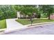 View of a well-maintained lawn, long driveway, and the house's facade from the street at 60 Heritage Keep, Covington, GA 30016