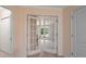 Hallway featuring double doors leading to another room, with access to closets and a powder room at 60 Heritage Keep, Covington, GA 30016