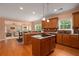Spacious kitchen featuring an island, wooden cabinets, and a view into the living room at 60 Heritage Keep, Covington, GA 30016