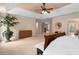Spacious main bedroom with tray ceilings, neutral tones, access to the ensuite, and bright windows at 60 Heritage Keep, Covington, GA 30016