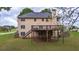 The rear of the home features a large wooden deck overlooking the backyard at 60 Heritage Keep, Covington, GA 30016