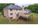 The home's back exterior features a large wooden deck and a grassy backyard at 60 Heritage Keep, Covington, GA 30016