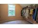 Organized walk-in closet with hanging racks and shelving for ample clothing and shoe storage at 60 Heritage Keep, Covington, GA 30016