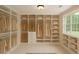 Spacious walk-in closet featuring custom built-in shelving and ample storage for clothes and accessories at 60 Heritage Keep, Covington, GA 30016