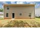 A view of the house's backyard showcases a simple and tidy landscape at 1023 Saint Augustine Pkwy, Locust Grove, GA 30248