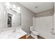 Bathroom with wood vanity, framed mirror, modern faucet, and updated bath and shower at 1023 Saint Augustine Pkwy, Locust Grove, GA 30248