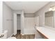 Bright bathroom features a tub, vanity, and an open closet for extra storage at 1023 Saint Augustine Pkwy, Locust Grove, GA 30248