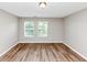 Bright bedroom with fresh paint, natural light from two windows, and clean vinyl floors at 1023 Saint Augustine Pkwy, Locust Grove, GA 30248