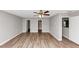 Bedroom with ceiling fan, fresh paint, laminate floors, and two closet doors at 1023 Saint Augustine Pkwy, Locust Grove, GA 30248