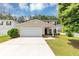 Charming two-story home featuring a well-manicured lawn and an attached two-car garage at 1023 Saint Augustine Pkwy, Locust Grove, GA 30248