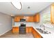Kitchen with wood cabinets, stainless appliances, light countertops and wood floors at 1023 Saint Augustine Pkwy, Locust Grove, GA 30248