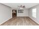 Open-concept living room showcasing hardwood flooring, large windows, and an opening to the kitchen at 1023 Saint Augustine Pkwy, Locust Grove, GA 30248