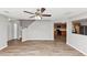 A modern living area featuring hardwood floors, grey walls, and a view into the kitchen at 1023 Saint Augustine Pkwy, Locust Grove, GA 30248
