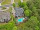 Aerial view of a charming landscaped property with a pool, shed, and lush greenery in a suburban neighborhood at 1985 Chapel Estates Ln, Dacula, GA 30019