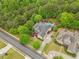 Bird's eye view of a landscaped home with a pool, lush greenery, shed, and spacious driveway at 1985 Chapel Estates Ln, Dacula, GA 30019