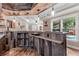 A rustic finished bar with wood countertops, cabinetry, modern lighting, and access to the pool area at 1985 Chapel Estates Ln, Dacula, GA 30019