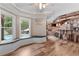 Bright bar area featuring a window bench, natural light, hardwood floors, and modern finishes at 1985 Chapel Estates Ln, Dacula, GA 30019