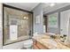 Bathroom featuring a shower with glass door, granite countertop, and modern fixtures at 1985 Chapel Estates Ln, Dacula, GA 30019