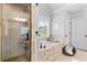 Bright bathroom with a large soaking tub, tiled shower, and plenty of natural light at 1985 Chapel Estates Ln, Dacula, GA 30019