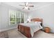Cozy bedroom features a ceiling fan and a large window at 1985 Chapel Estates Ln, Dacula, GA 30019