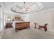 Spacious bedroom with tray ceiling, plush carpet, and large windows offers a tranquil retreat at 1985 Chapel Estates Ln, Dacula, GA 30019
